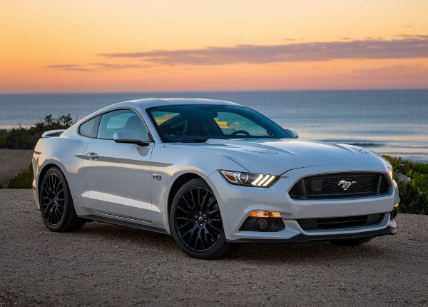 White Ford Mustang with sunset behind in Cleveland